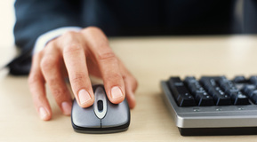 Mans hand on computer mouse